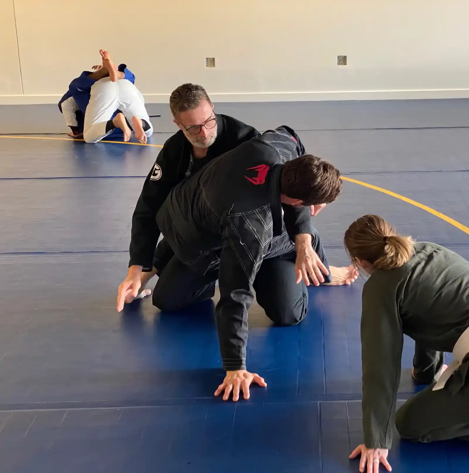 Instructor Tom teaching whitebelts a hip bump sweep